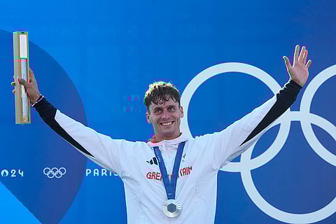 Men's slalom C-1 medal ceremony: Silver medalist Adam Burgess, of Britain